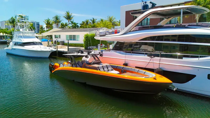 Slide: The Image of 2022 Midnight Express 43 Open boat docked beside luxury yachts in a sunny marina. - 34
