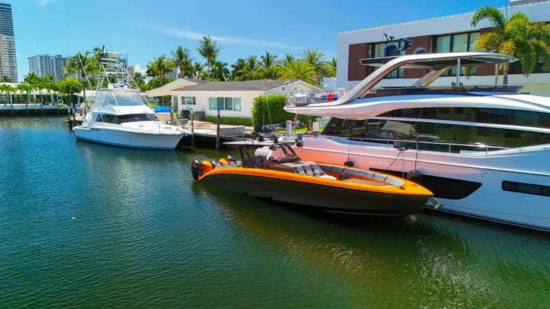 Slide: The Image of 2022 Midnight Express 43 Open yacht docked beside luxury boats in a sunny marina. - 35