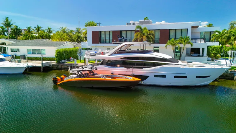 Slide: The Image of 2022 Midnight Express 43 Open yacht docked by modern waterfront homes. - 38