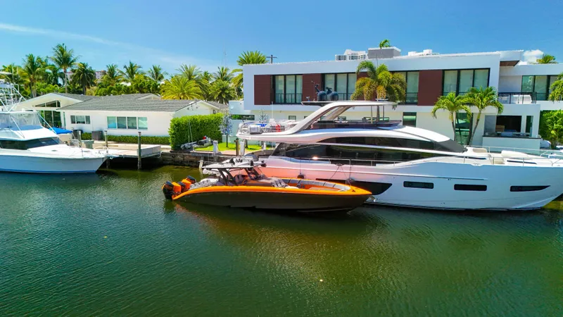 Slide: The Image of 2022 Midnight Express 43 Open yacht docked beside luxury waterfront homes. - 41