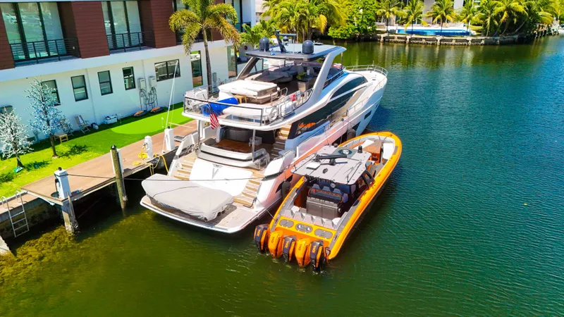 Slide: The Image of Luxury yacht and 2022 Midnight Express 43 Open docked by waterfront home. - 42