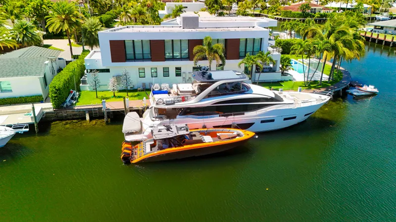 Slide: The Image of Luxury yacht and 2022 Midnight Express 43 Open docked by modern waterfront home. - 45