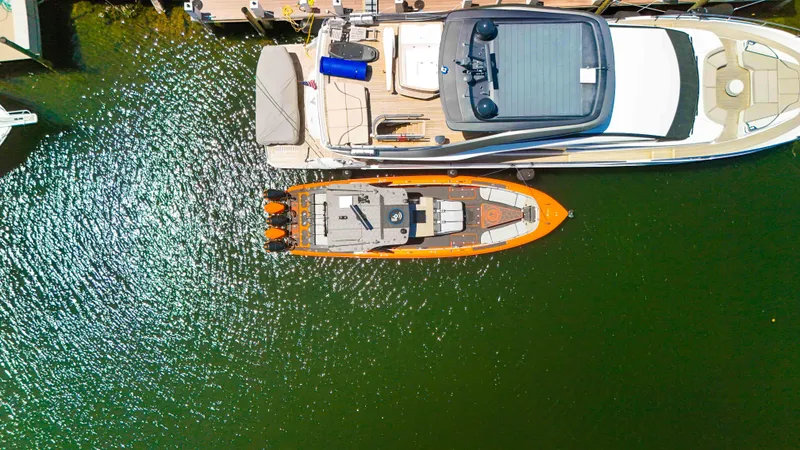 Slide: The Image of Aerial view of 2022 Midnight Express 43 Open boat docked beside a larger yacht. - 47