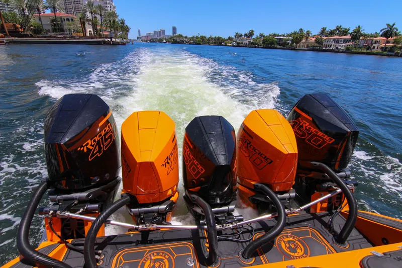 Slide: The Image of 2022 Midnight Express 43 Open boat with four powerful outboard engines on a sunny waterway. - 5