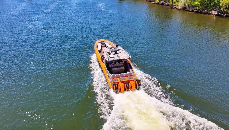 Slide: The Image of 2022 Midnight Express 43 Open boat cruising on a sunny waterway. - 7
