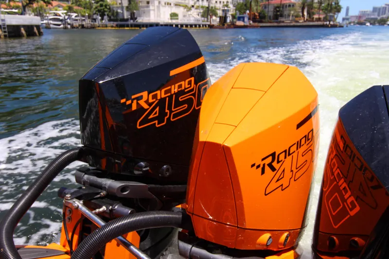 Slide: The Image of Triple Racing 450 outboard engines on a 2022 Midnight Express 43 Open boat. - 9