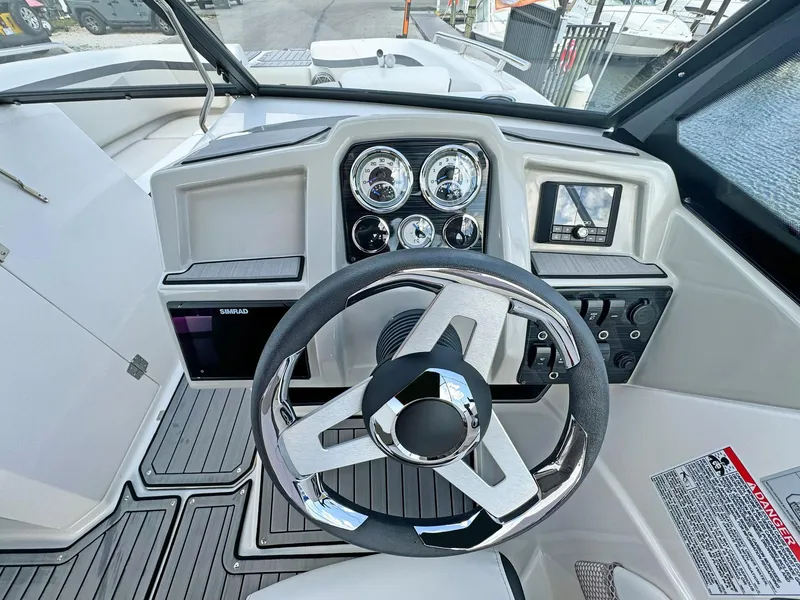Slide: The Image of 2024 Starcraft SVX 230 OB boat dashboard with steering wheel and control panel. - 10