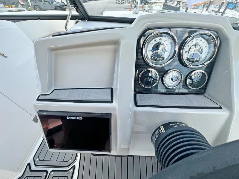 Slide: The Image of 2024 Starcraft SVX 230 OB dashboard with gauges and Simrad display. - 11