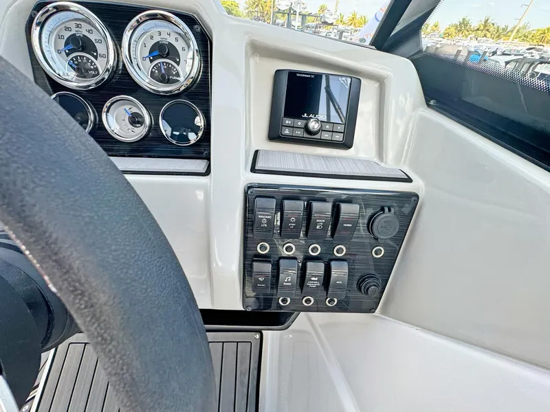 Slide: The Image of 2024 Starcraft SVX 230 OB dashboard with gauges and control panel. - 12