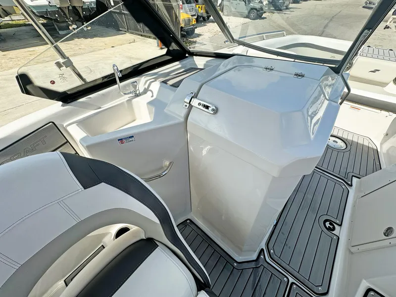 Slide: The Image of 2024 Starcraft SVX 230 OB boat interior with sleek seating and modern dashboard design. - 13