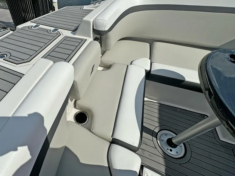 Slide: The Image of 2024 Starcraft SVX 230 OB boat interior with cushioned seating and table. - 17