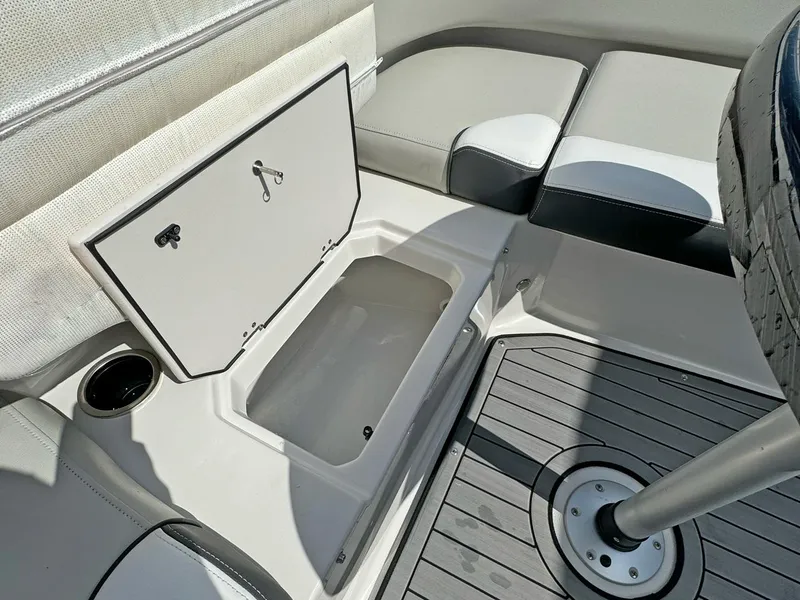 Slide: The Image of 2024 Starcraft SVX 230 OB boat interior with open storage compartment and seating. - 18
