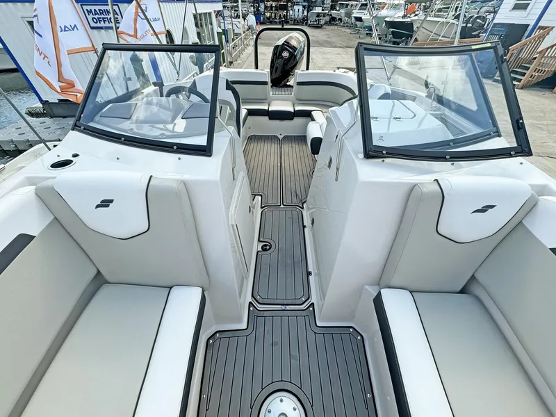 Slide: The Image of 2024 Starcraft SVX 230 OB boat interior with dual consoles and seating. - 20