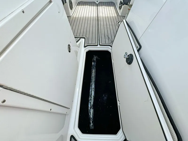 Slide: The Image of 2024 Starcraft SVX 230 OB boat storage compartment with open hatch, showcasing interior space. - 21