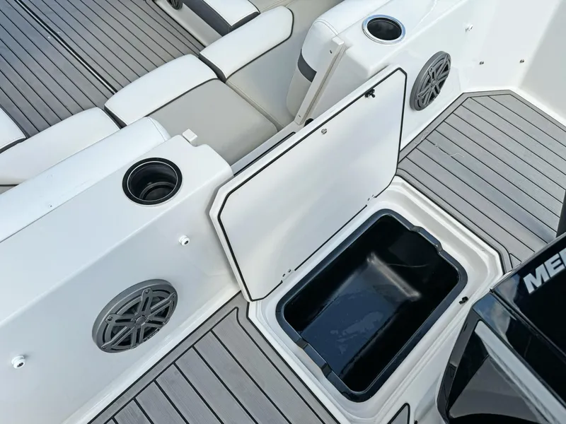 Slide: The Image of 2024 Starcraft SVX 230 OB boat interior with open storage compartment and seating. - 28