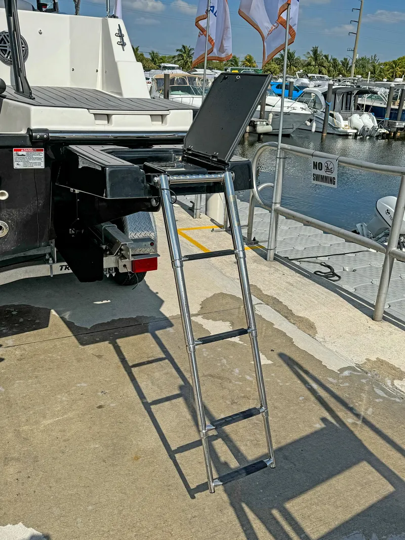 Slide: The Image of 2024 Starcraft SVX 230 OB boat with extended ladder at marina dock. - 29
