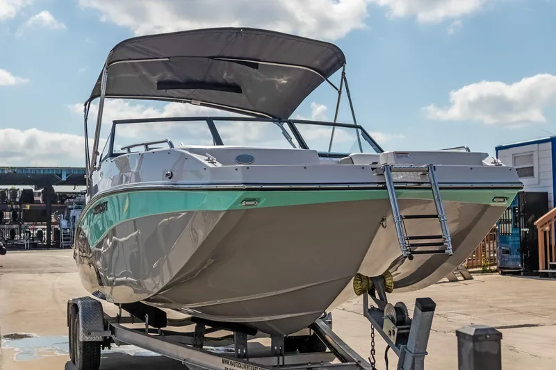 Slide: The Image of 2024 Starcraft SVX 230 OB boat on trailer under blue sky. - 5
