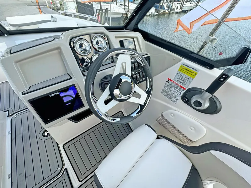 Slide: The Image of 2024 Starcraft SVX 230 OB boat dashboard with steering wheel and control panel. - 9