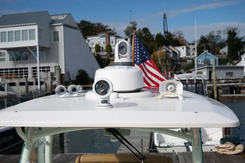Slide: The Image of 2016 Hunt Yachts 32 Center Console docked with American flag, marina background. - 14