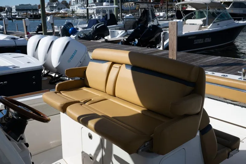 Slide: The Image of 2016 Hunt Yachts 32 Center Console boat with American flag, docked on a sunny day. - 23
