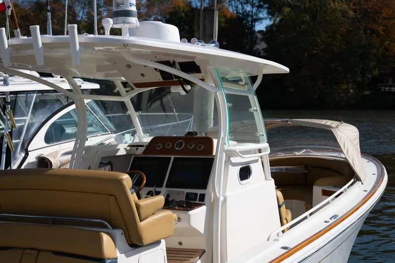 Slide: The Image of 2016 Hunt Yachts 32 Center Console with tan seating at a marina. - 24