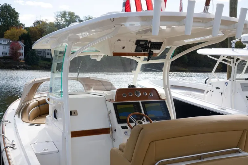 Slide: The Image of 2016 Hunt Yachts 32 Center Console on a scenic lake with autumn trees. - 3