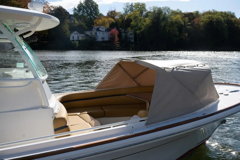 Slide: The Image of 2016 Hunt Yachts 32 Center Console boat with American flag on a calm river. - 39