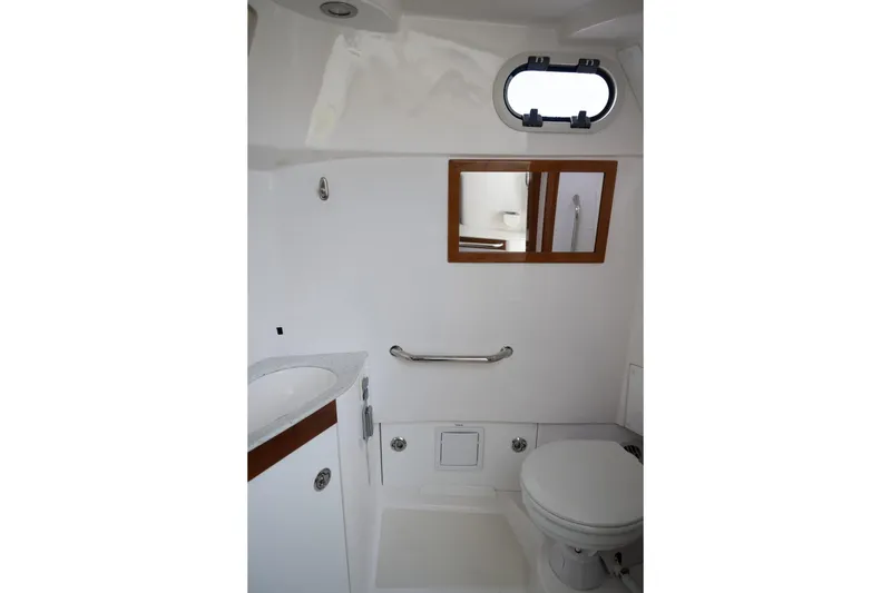 Slide: The Image of 2016 Hunt Yachts 32 Center Console interior bathroom with toilet and control panel. - 46
