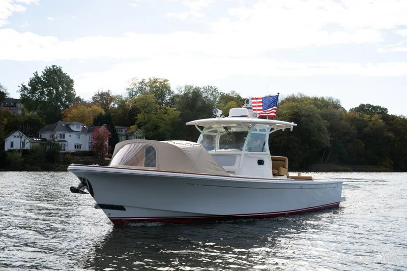Slide: The Image of 2016 Hunt Yachts 32 Center Console on a scenic lake with American flag. - 5
