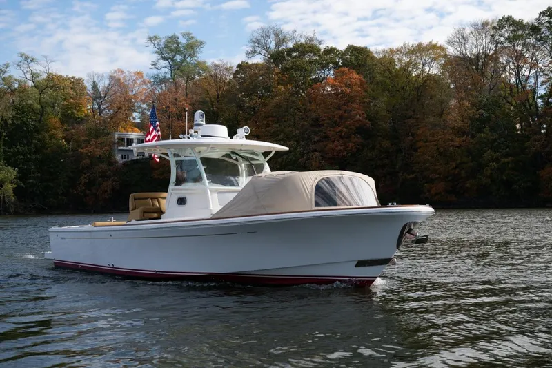 Slide: The Image of 2016 Hunt Yachts 32 Center Console on a scenic lake with autumn foliage. - 6