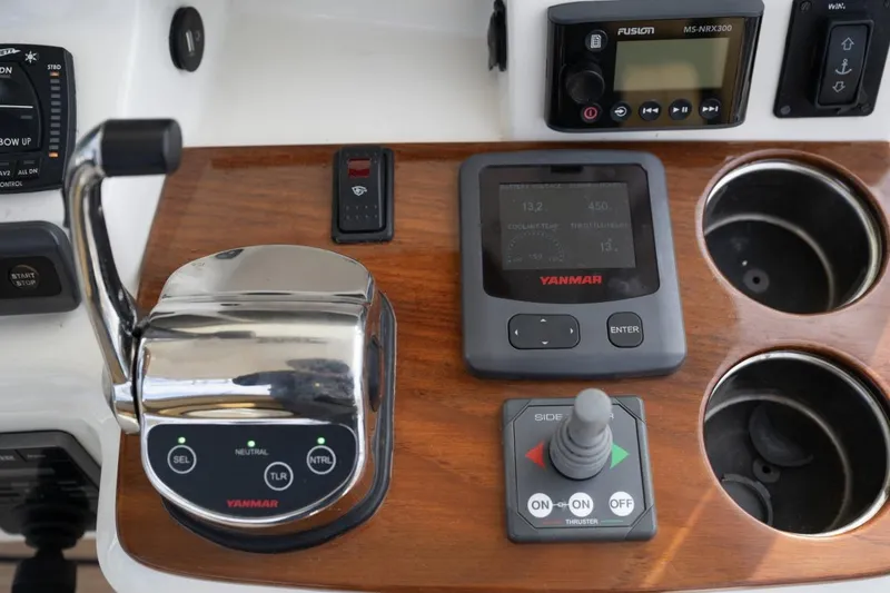 Slide: The Image of 2016 Hunt Yachts 32 Center Console dashboard with dual navigation screens and wooden steering wheel. - 18