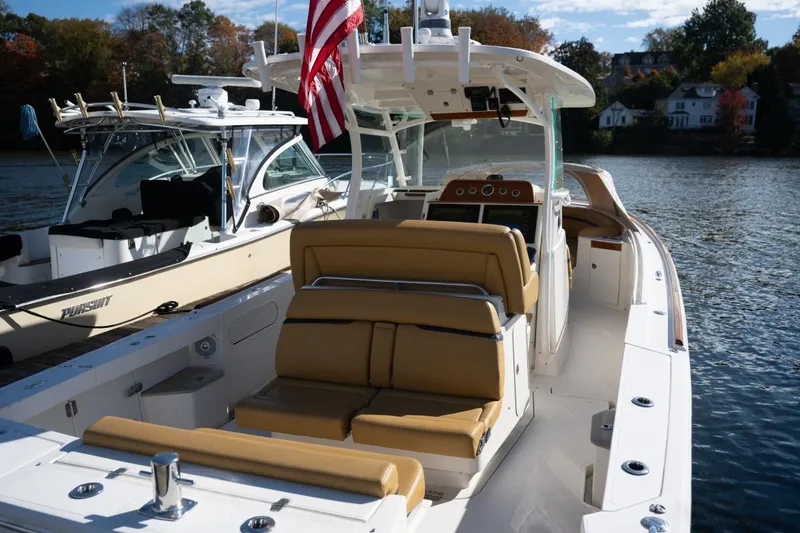 Slide: The Image of 2016 Hunt Yachts 32 Center Console with tan seating and modern dashboard. - 25