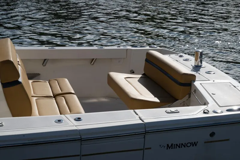 Slide: The Image of 2016 Hunt Yachts 32 Center Console with tan seating, docked at a wooden pier. - 33