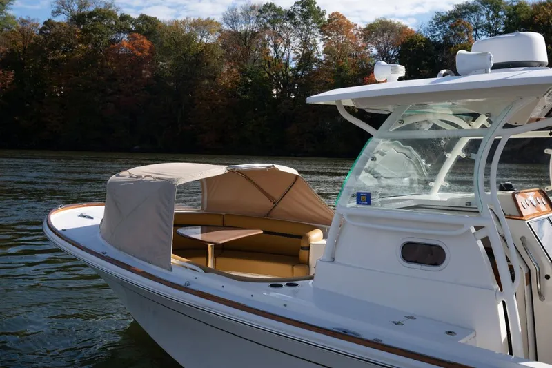 Slide: The Image of 2016 Hunt Yachts 32 Center Console docked at a marina with scenic waterfront views. - 36