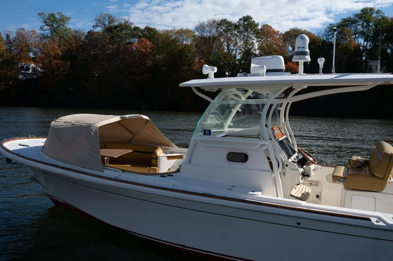 Slide: The Image of 2016 Hunt Yachts 32 Center Console on calm water with autumn trees in background. - 37