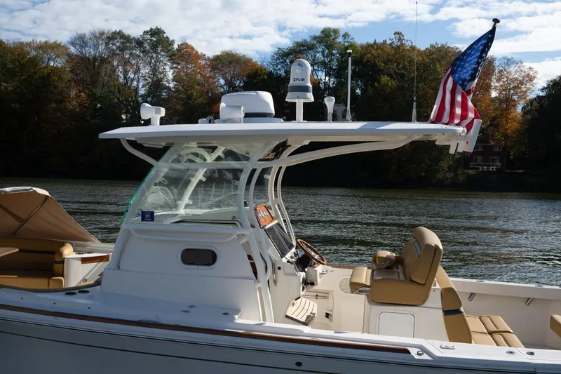 Slide: The Image of 2016 Hunt Yachts 32 Center Console on a serene river with autumn foliage. - 38
