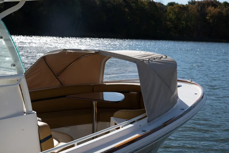 Slide: The Image of 2016 Hunt Yachts 32 Center Console on a serene lake with lush trees. - 40