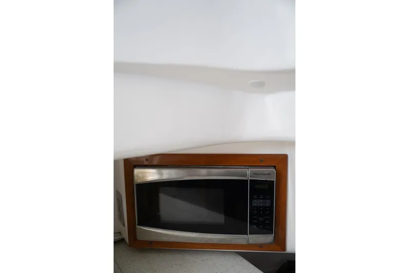 Slide: The Image of 2016 Hunt Yachts 32 Center Console bathroom interior with sink, toilet, and mirror. - 47