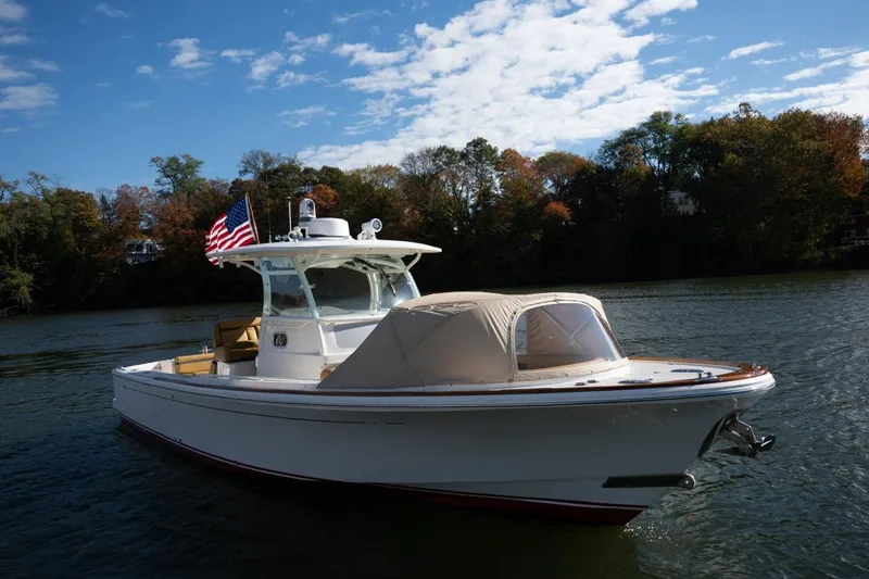Slide: The Image of 2016 Hunt Yachts 32 Center Console boat with American flag on water. - 8