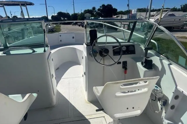 Slide: The Image of 2000 Angler Dual Console boat interior with steering wheel and seating. - 4