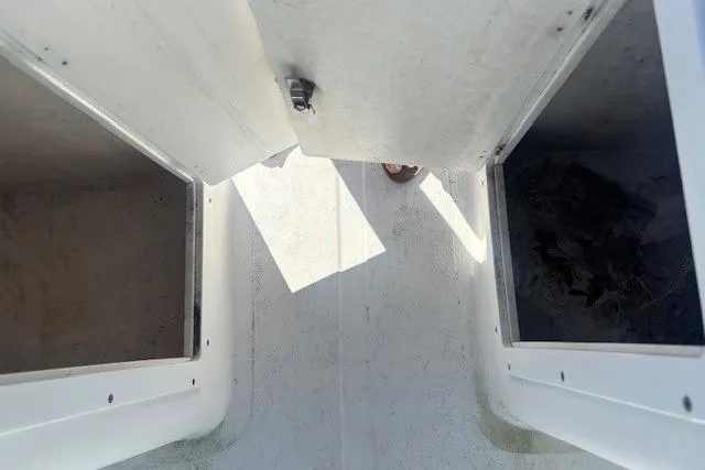 Slide: The Image of Interior view of a 2000 Angler Dual Console boat storage compartments. - 7