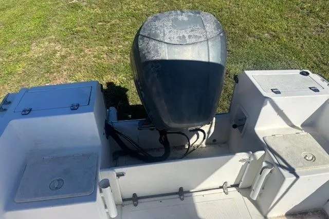 Slide: The Image of 2000 Angler Dual Console boat with outboard motor on grassy area. - 9