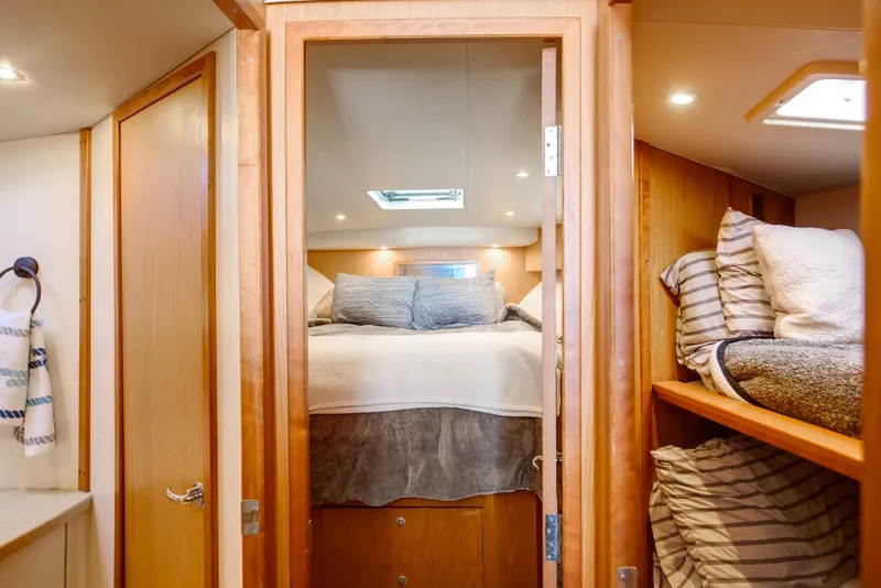 Slide: The Image of 2007 Luhrs Tournament 360 Open cabin interior with cozy bed and bunk beds. - 13