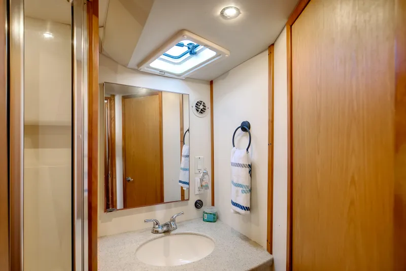 Slide: The Image of Bathroom interior of 2007 Luhrs Tournament 360 Open boat, featuring sink and mirror. - 16