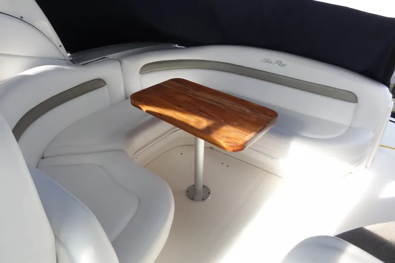 Slide: The Image of 2007 Sea Ray 320 Sundancer interior with white seating and wooden table. - 11