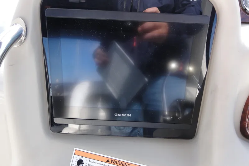 Slide: The Image of Garmin display on 2007 Sea Ray 320 Sundancer boat dashboard with warning label. - 13