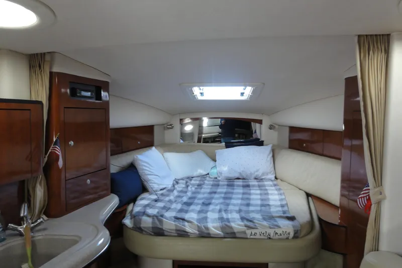 Slide: The Image of Interior cabin of 2007 Sea Ray 320 Sundancer with cozy bed and wooden cabinetry. - 20
