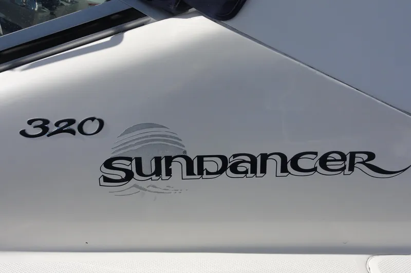 Slide: The Image of 2007 Sea Ray 320 Sundancer boat logo on white surface. - 5