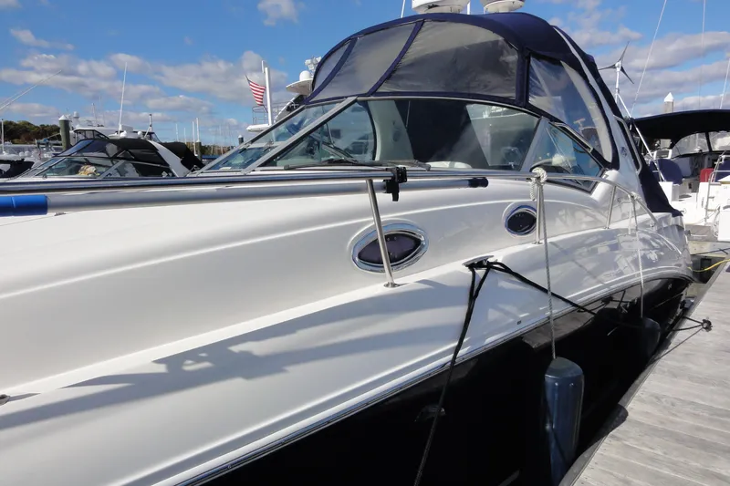 Slide: The Image of 2007 Sea Ray 320 Sundancer docked at marina under blue sky. - 6
