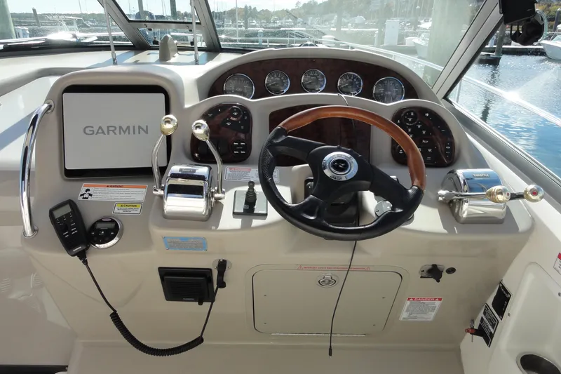 Slide: The Image of 2007 Sea Ray 320 Sundancer helm with Garmin navigation, steering wheel, and control panel. - 9
